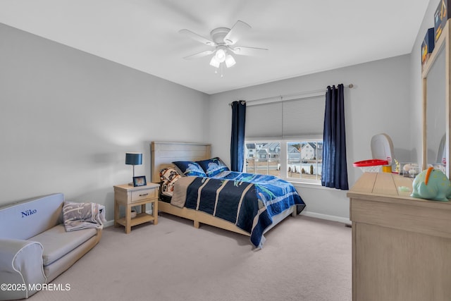 bedroom featuring baseboards, a ceiling fan, and light colored carpet