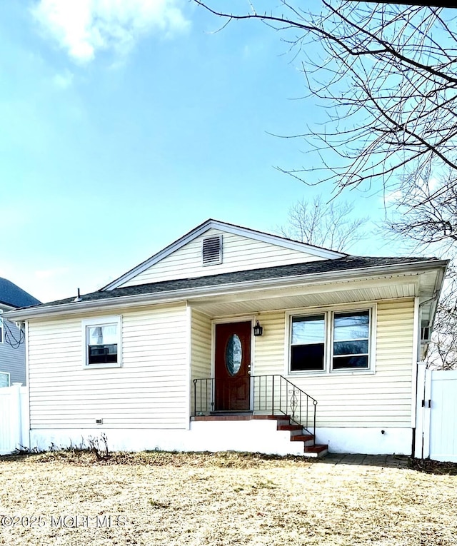 view of front of property featuring fence