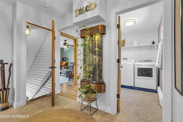 foyer featuring light tile patterned floors, independent washer and dryer, and a ceiling fan