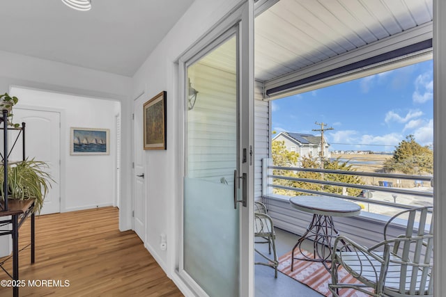 interior space featuring baseboards and wood finished floors