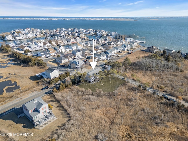 birds eye view of property with a residential view and a water view