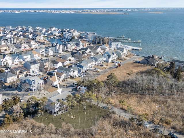 drone / aerial view featuring a residential view and a water view