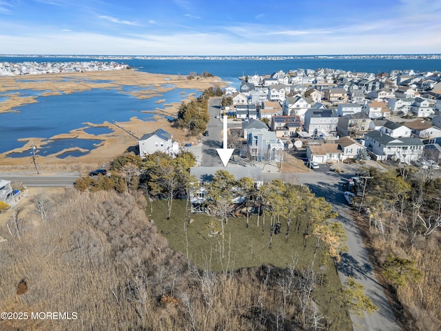 aerial view featuring a water view and a residential view