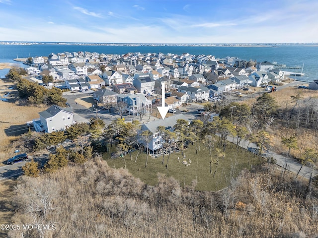 drone / aerial view featuring a residential view and a water view