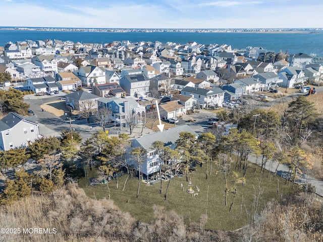 drone / aerial view with a residential view and a water view