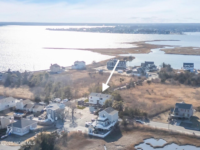 drone / aerial view featuring a water view and a residential view