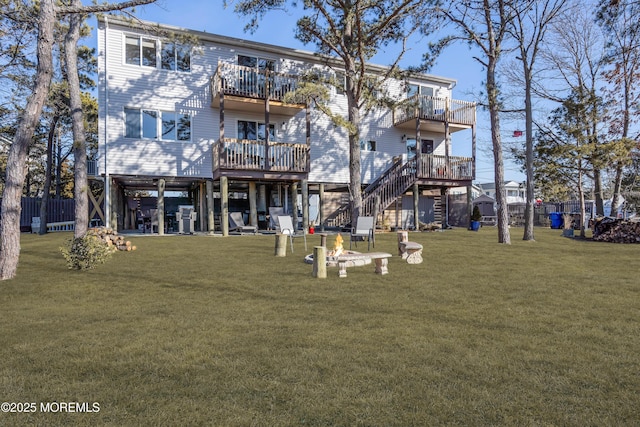 back of property featuring stairway, a balcony, a fire pit, and a yard