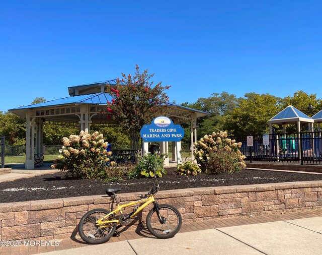 view of home's community with a gazebo, fence, and playground community