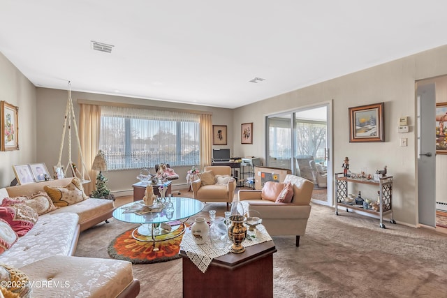 carpeted living room with visible vents and baseboard heating