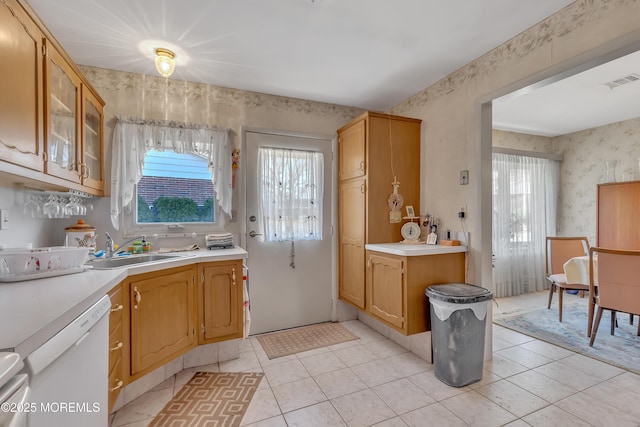 kitchen featuring light countertops, a healthy amount of sunlight, visible vents, and wallpapered walls