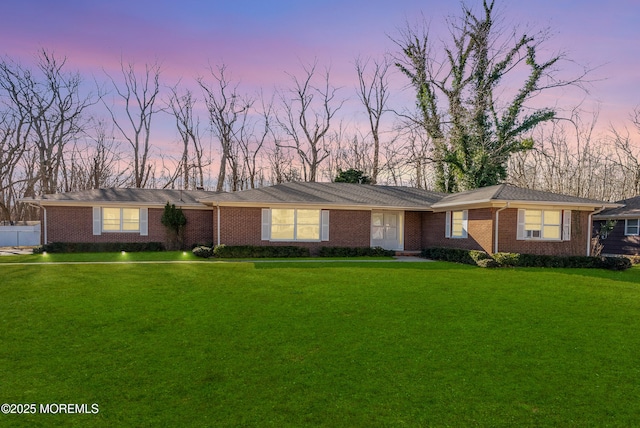 ranch-style house with brick siding and a front yard