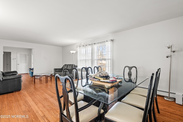 dining area with light wood-style flooring