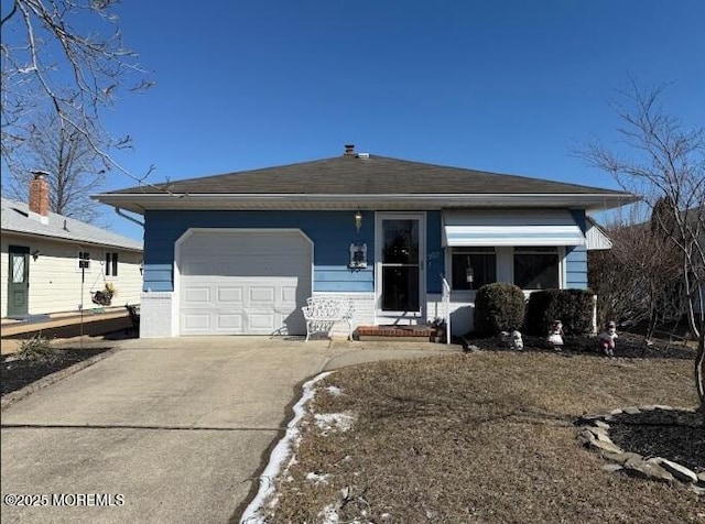 view of front of home featuring an attached garage and concrete driveway