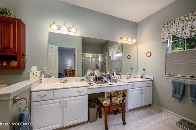 full bath with a stall shower, tile patterned flooring, vanity, and baseboards