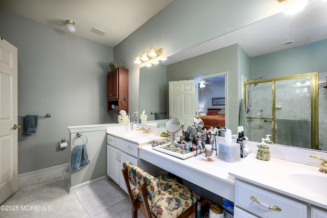 full bath featuring double vanity, a stall shower, visible vents, tile patterned floors, and a sink