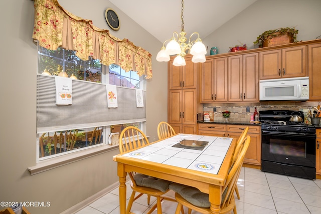 kitchen featuring black range with gas cooktop, white microwave, light tile patterned flooring, vaulted ceiling, and backsplash