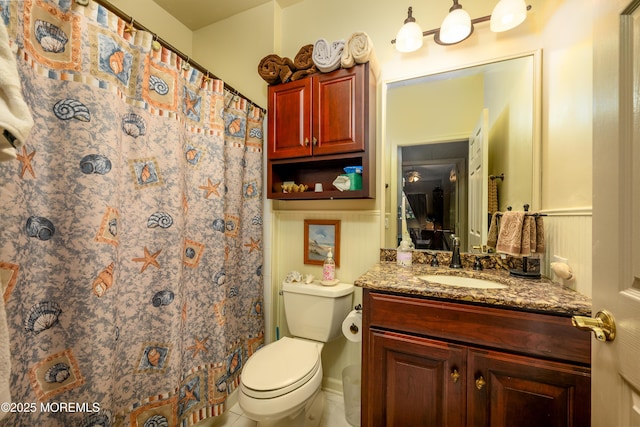 full bathroom with a shower with shower curtain, vanity, and toilet