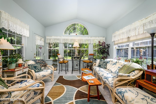 sunroom / solarium featuring vaulted ceiling