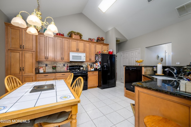 kitchen with visible vents, brown cabinetry, an inviting chandelier, black appliances, and a sink