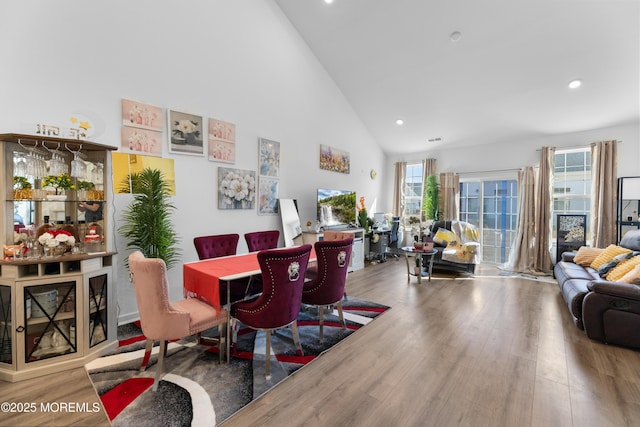 dining area featuring high vaulted ceiling, wood finished floors, visible vents, and recessed lighting