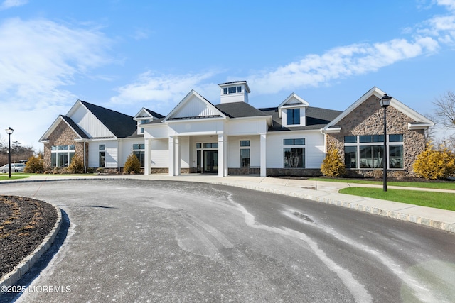 view of front of property featuring stone siding and board and batten siding