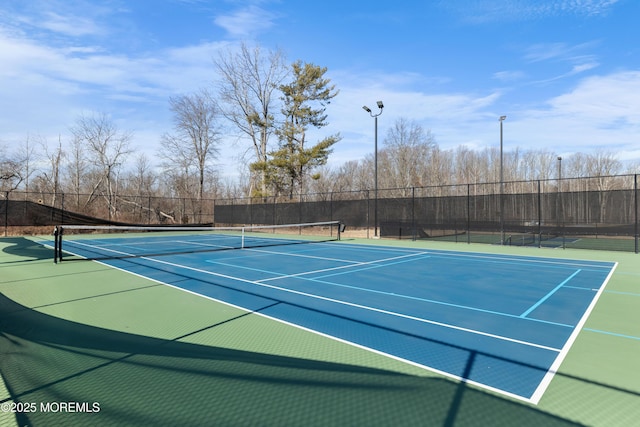 view of sport court with fence