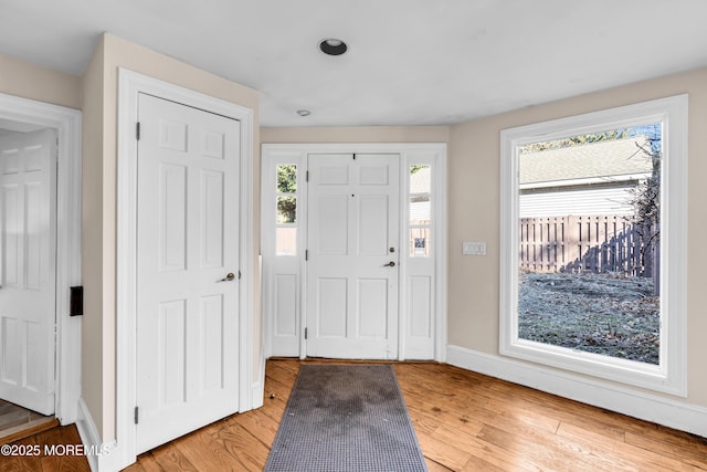 foyer featuring light wood-type flooring and baseboards