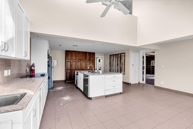 kitchen with decorative backsplash, freestanding refrigerator, a sink, dishwasher, and baseboards