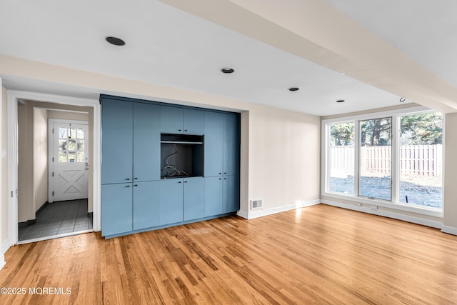 interior space with baseboards, a closet, visible vents, and light wood-style floors