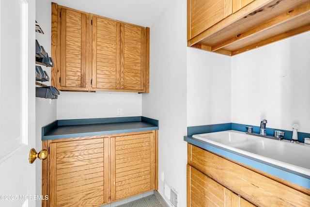 laundry area with a sink and visible vents