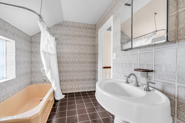 full bath featuring a sink, tile walls, and tile patterned floors