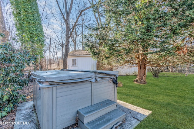 view of yard with a hot tub and an outbuilding