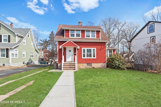 bungalow-style house with roof with shingles, a chimney, and a front yard