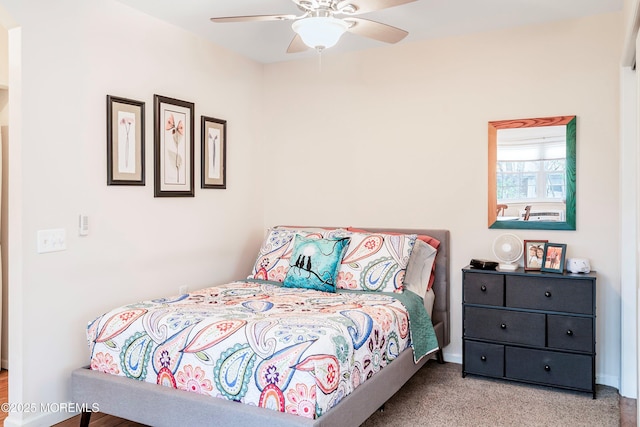 bedroom with a ceiling fan, carpet, and baseboards