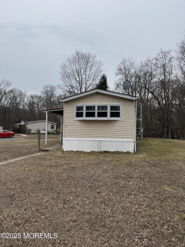 view of side of home with a yard