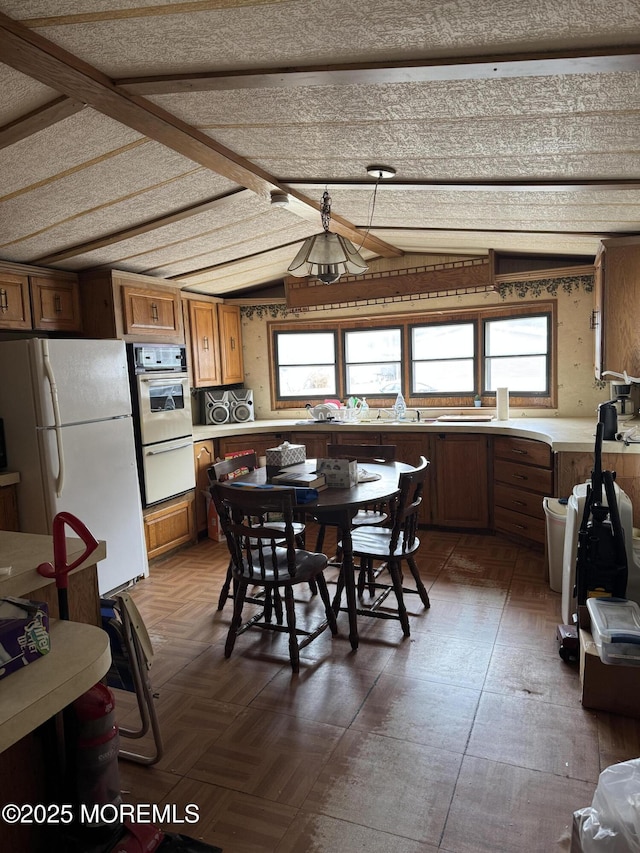 dining space featuring lofted ceiling and plenty of natural light