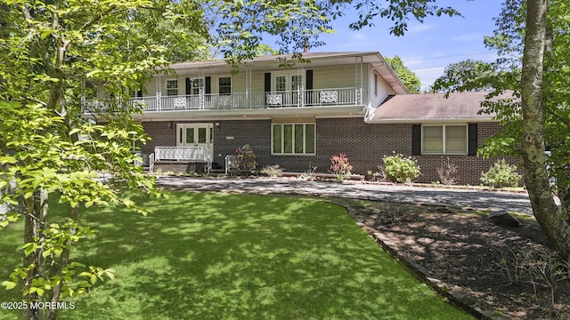 1759 Todd Rd, Toms River, NJ 08755 - view of front of property featuring french doors, a balcony, a front yard, and brick siding