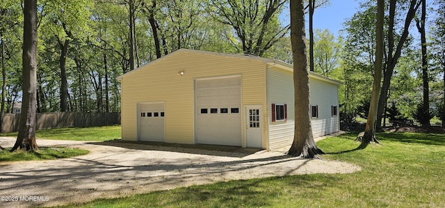 detached garage featuring fence