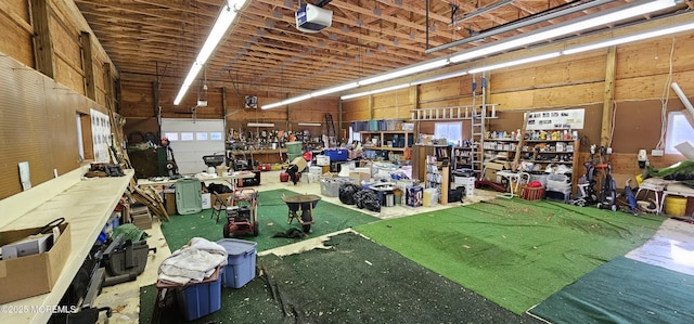 garage with a workshop area and a garage door opener