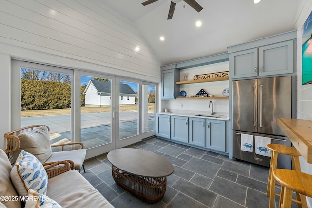 interior space featuring lofted ceiling, recessed lighting, french doors, stone finish floor, and indoor wet bar