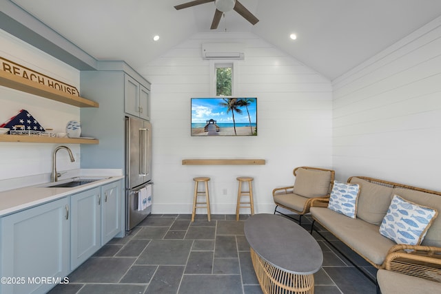 interior space with lofted ceiling, a ceiling fan, an AC wall unit, and recessed lighting