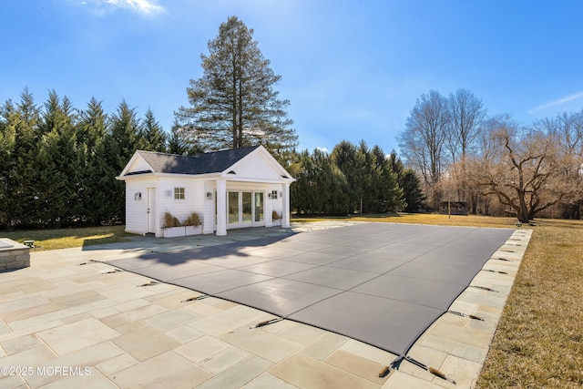 view of swimming pool with an outbuilding, a yard, a patio area, and an exterior structure