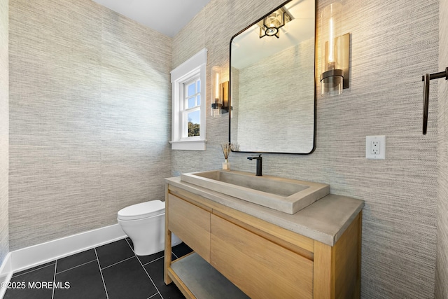 bathroom featuring toilet, vanity, and tile patterned floors