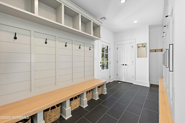 mudroom with recessed lighting, visible vents, baseboards, and dark tile patterned flooring