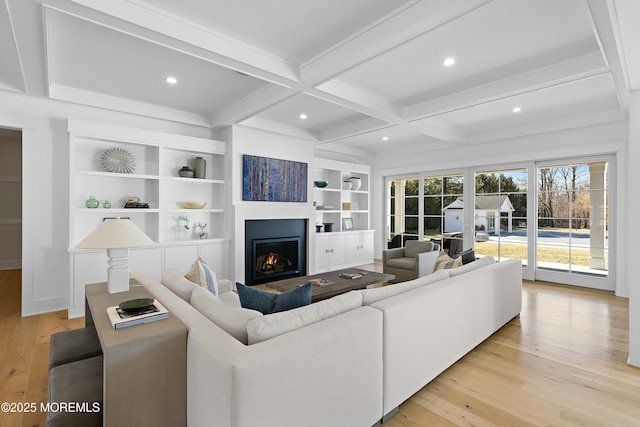 living room featuring recessed lighting, light wood-style floors, coffered ceiling, beamed ceiling, and a lit fireplace