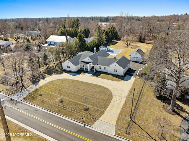 drone / aerial view featuring a wooded view