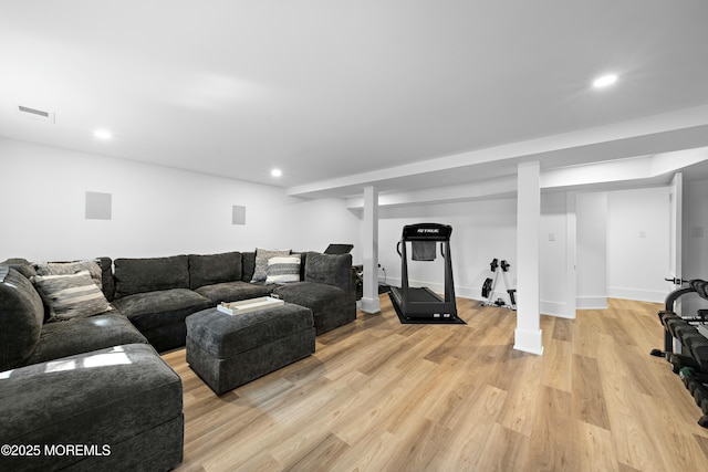 living room with baseboards, light wood-type flooring, visible vents, and recessed lighting