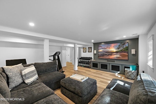 living room featuring stairway, visible vents, wood finished floors, and recessed lighting