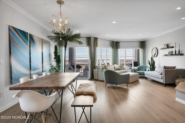 dining area featuring a chandelier, recessed lighting, crown molding, and wood finished floors