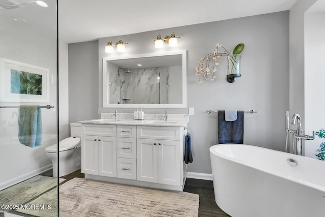 full bath with a freestanding bath, double vanity, a sink, and a marble finish shower